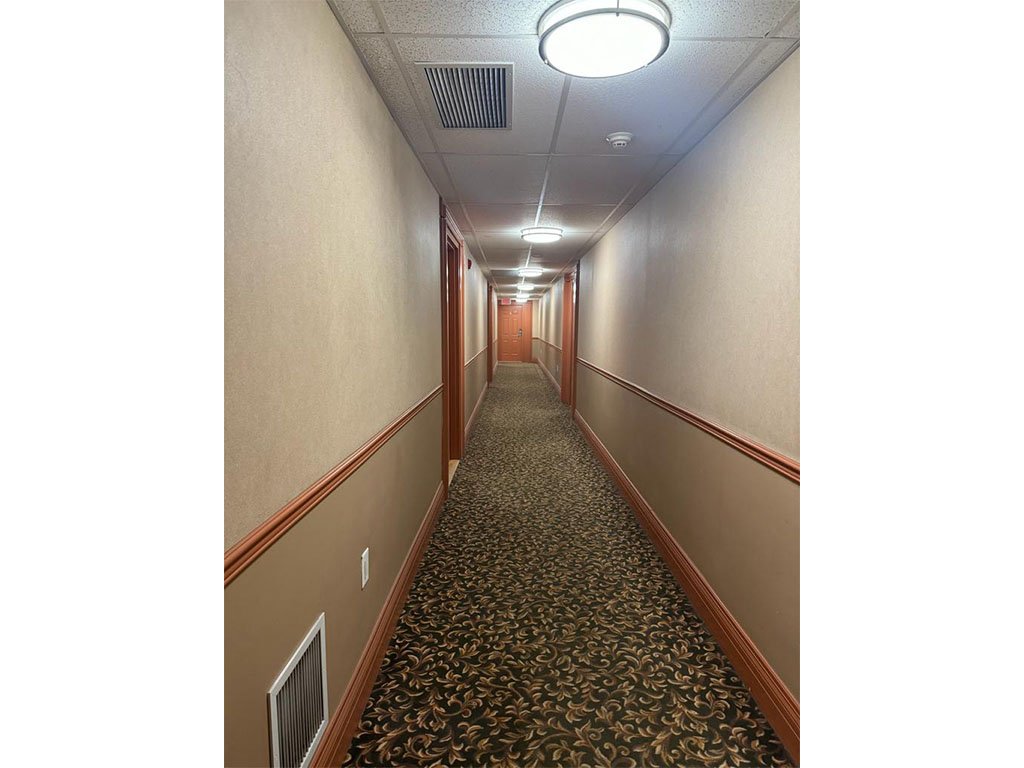 Grand Manor Condos Corridor before - Folio Interiors
